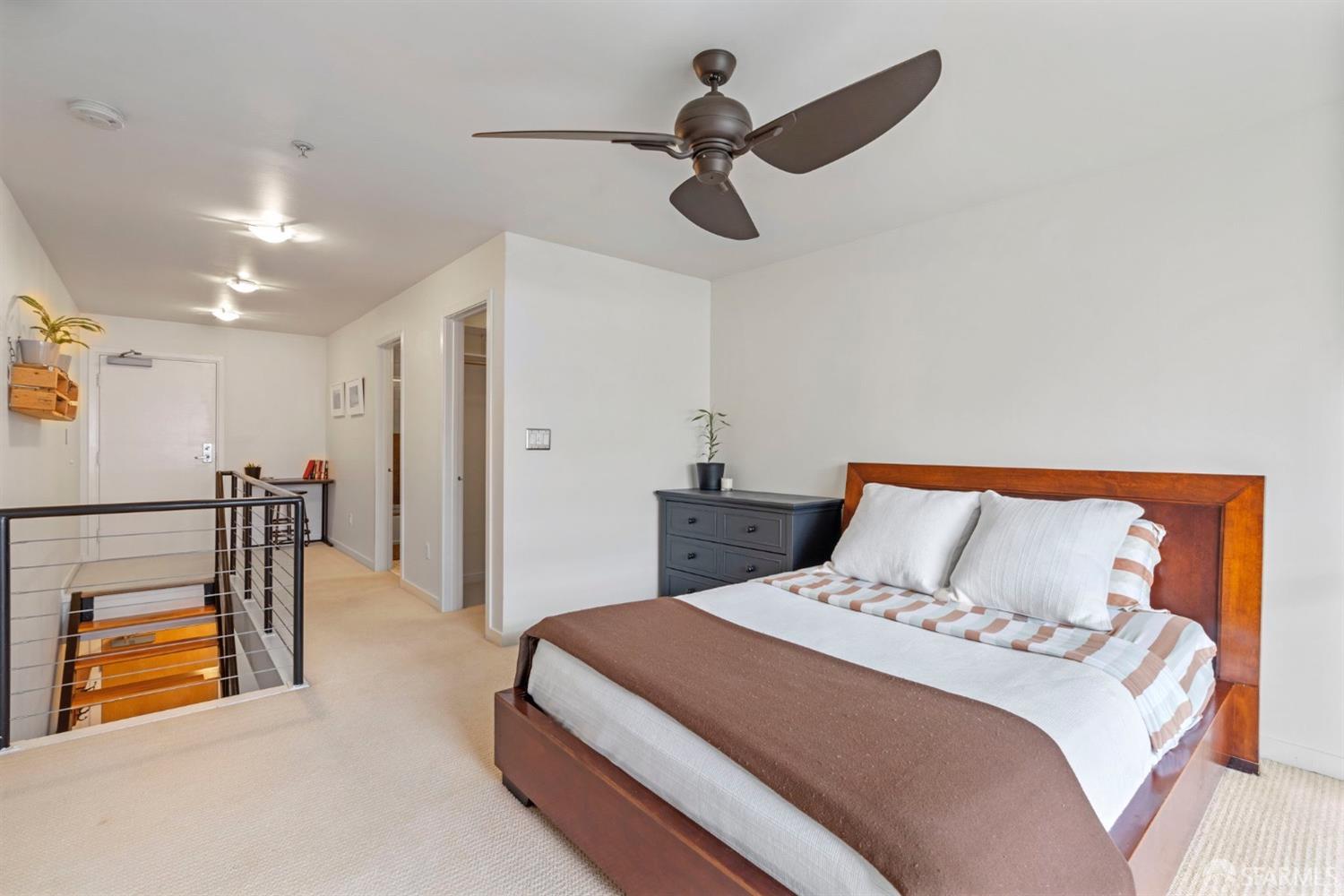 1720 Clay Street, Unit 8 San Francisco, CA 94109 - Photo 14 of 37 a bedroom with a bed and a chandelier