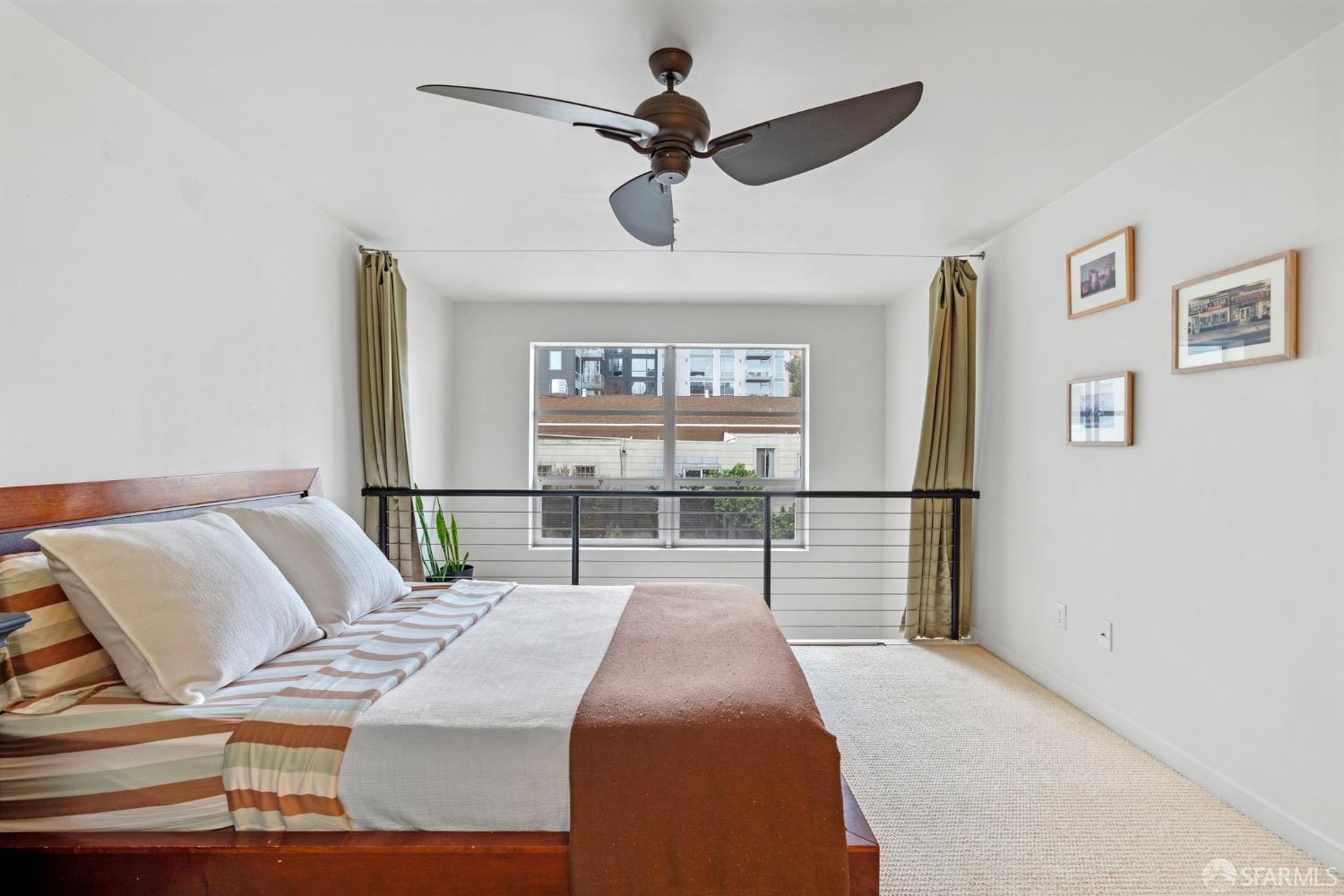 1720 Clay Street, Unit 8 San Francisco, CA 94109 - Photo 16 of 37 a bedroom with a bed and a chandelier