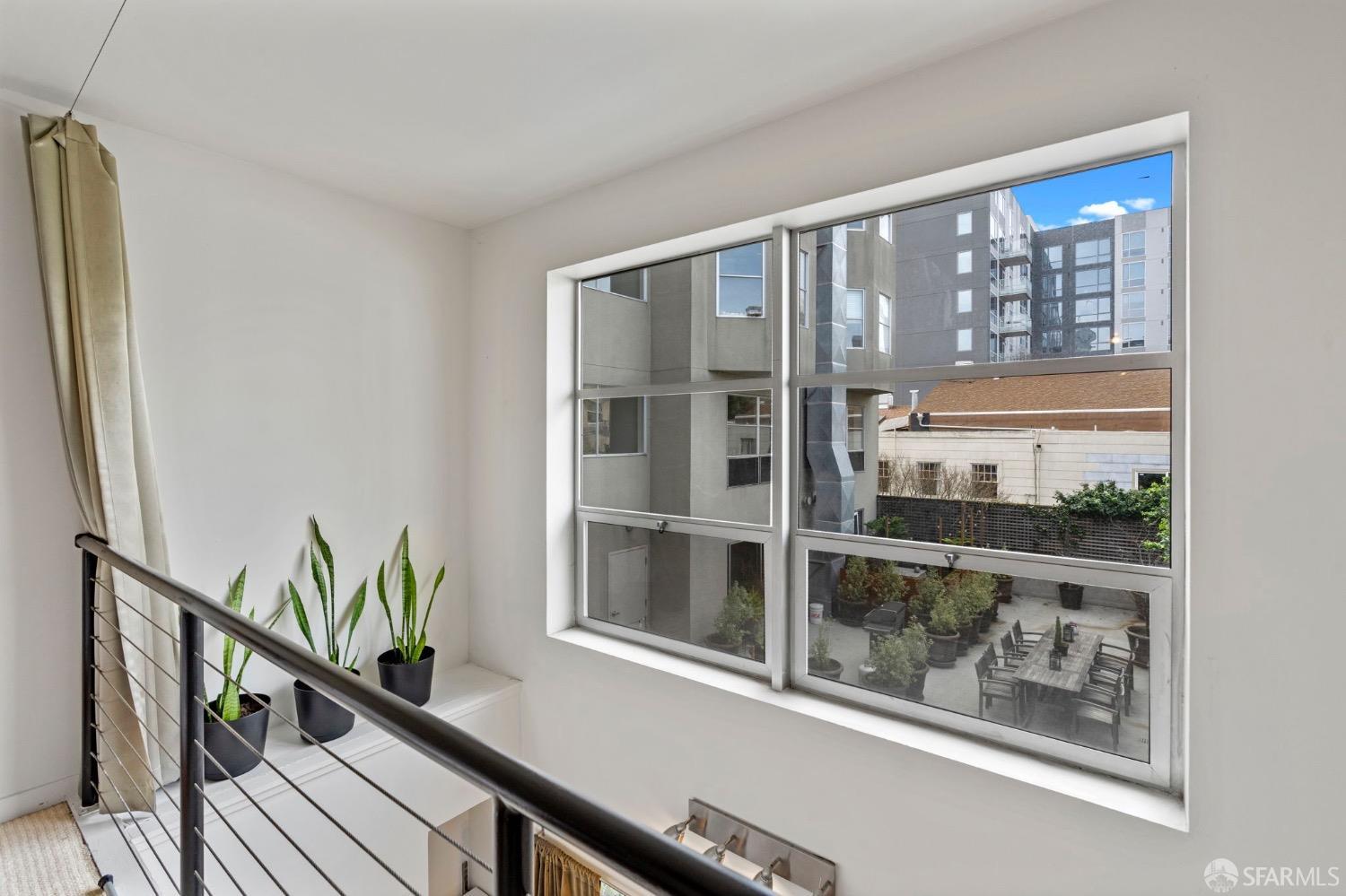 1720 Clay Street, Unit 8 San Francisco, CA 94109 - Photo 19 of 37 a view of a balcony with wooden floor and fence