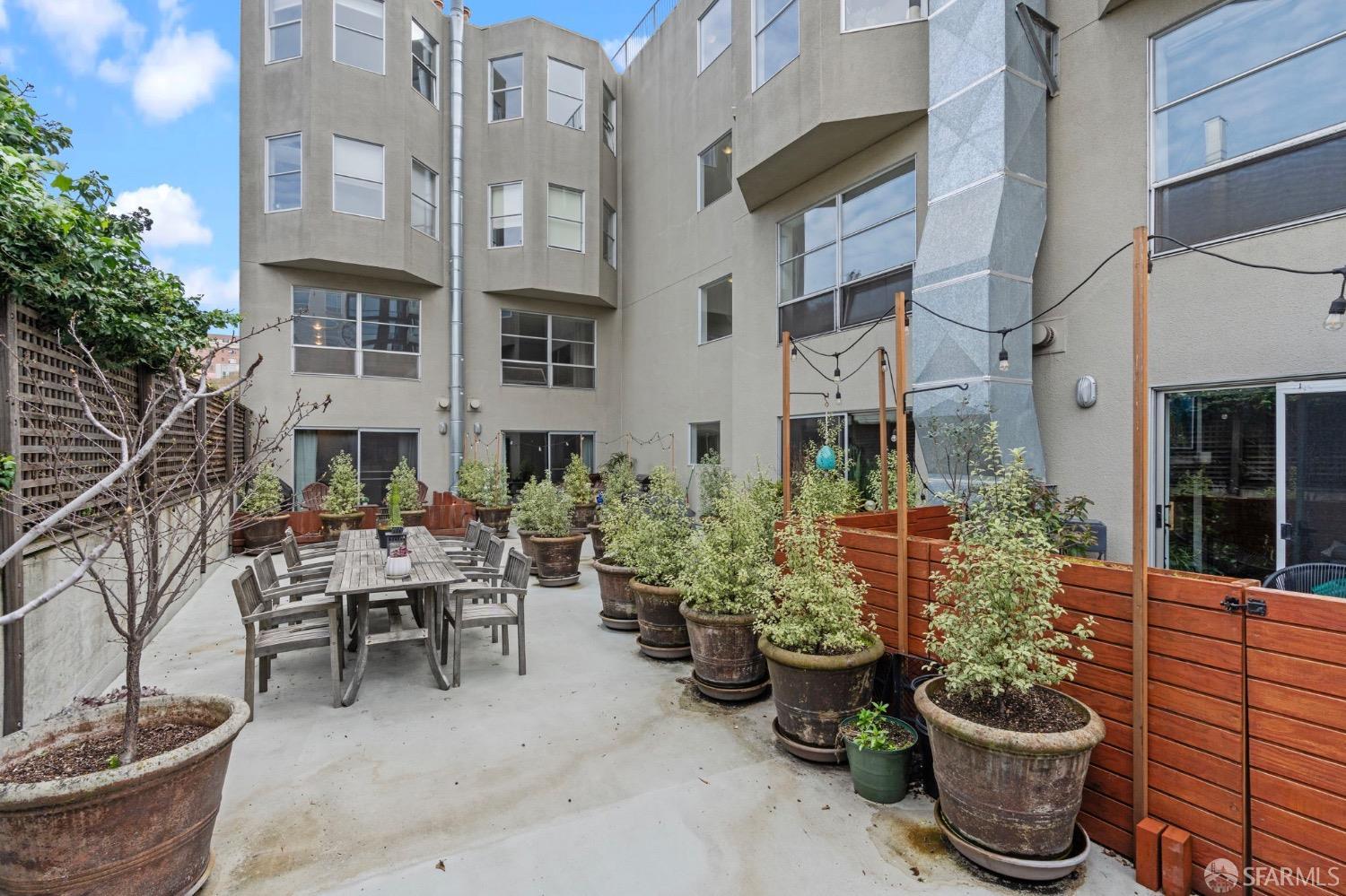 1720 Clay Street, Unit 8 San Francisco, CA 94109 - Photo 26 of 37 a view of a patio with plants and chairs potted plants