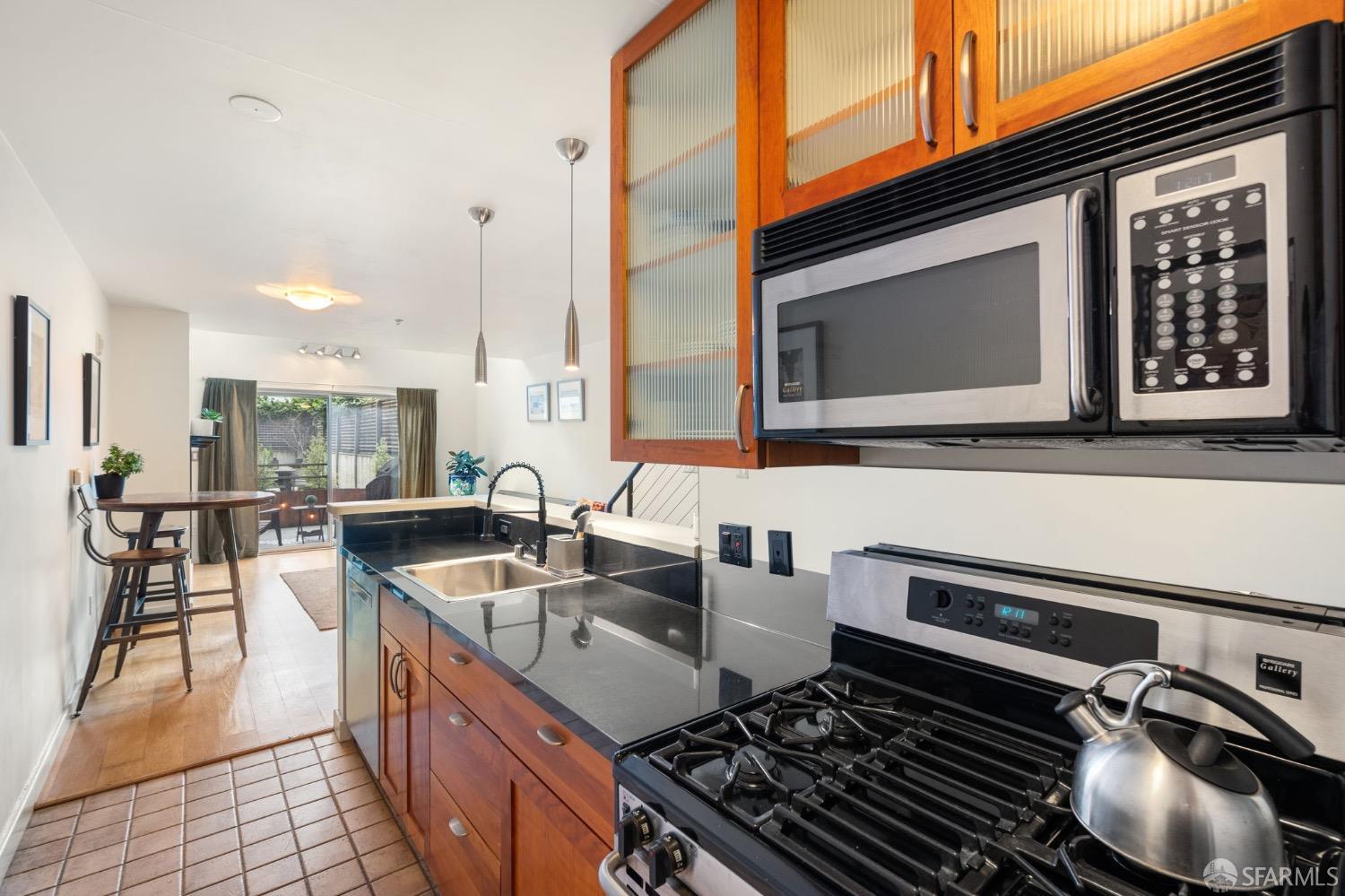 1720 Clay Street, Unit 8 San Francisco, CA 94109 - Photo 7 of 37 a kitchen with kitchen island granite countertop a stove and a sink