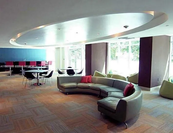 a room with pool table and potted plants