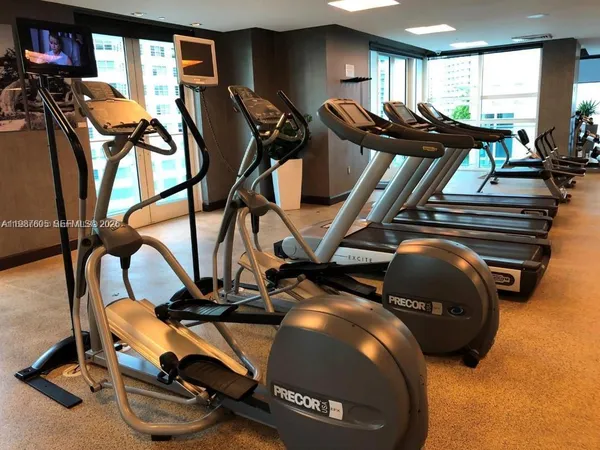 a view of a hallway with dining table and chairs