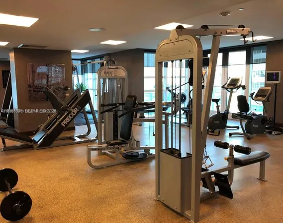 a lobby with furniture and floor to ceiling windows