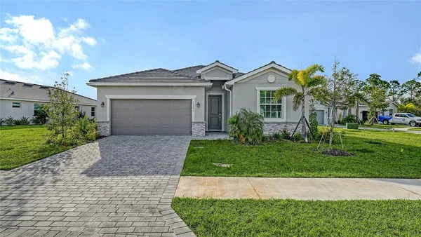 a front view of a house with a yard and garage