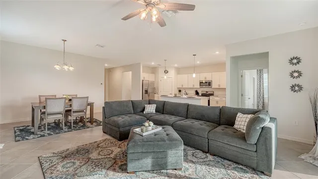 a kitchen with stainless steel appliances a white table and chairs