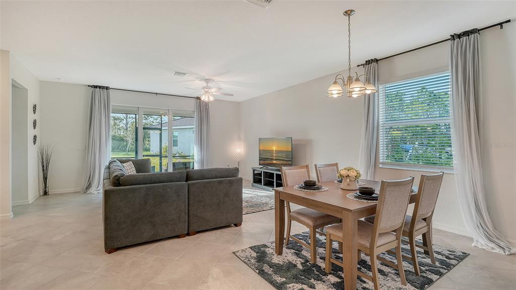 10896 Pinot Drive Venice, FL 34293 - Photo 13 of 70 a living room with furniture and a large window