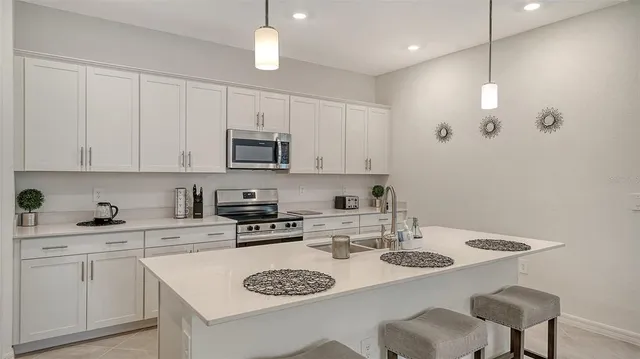 a bedroom with a large bed and a chandelier
