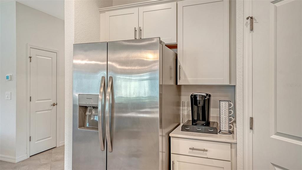 10896 Pinot Drive Venice, FL 34293 - Photo 16 of 70 a kitchen with a refrigerator and cabinets