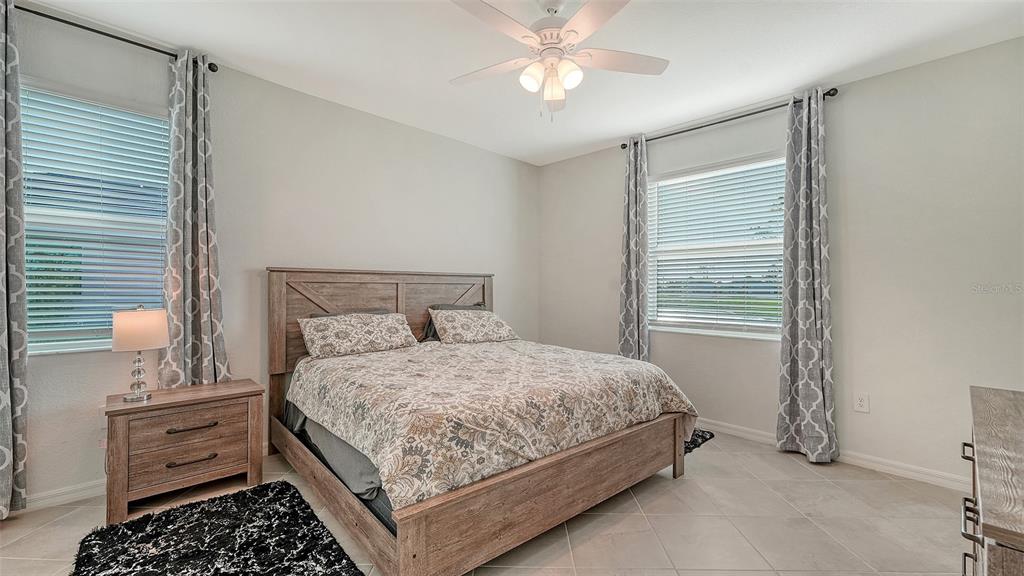 10896 Pinot Drive Venice, FL 34293 - Photo 18 of 70 a bedroom with a bed dresser and a window