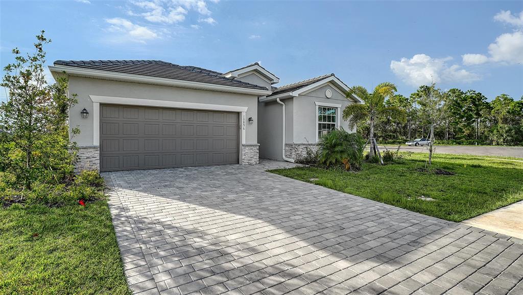 10896 Pinot Drive Venice, FL 34293 - Photo 2 of 70 a front view of house with yard and green space