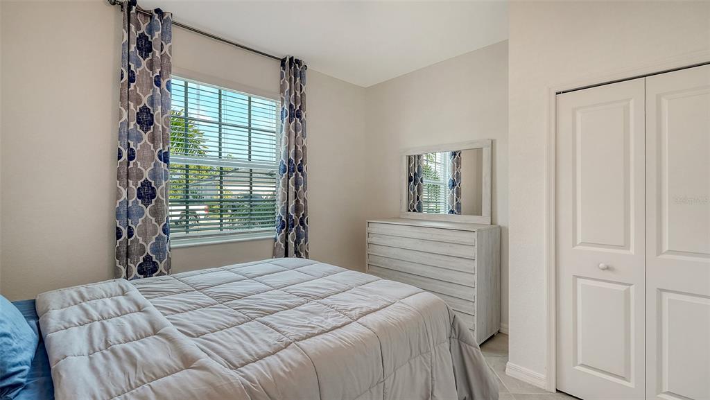 10896 Pinot Drive Venice, FL 34293 - Photo 28 of 70 a bedroom with a bed and a window
