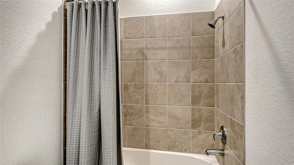10896 Pinot Drive Venice, FL 34293 - Photo 30 of 70 a bathroom with a bathtub and shower