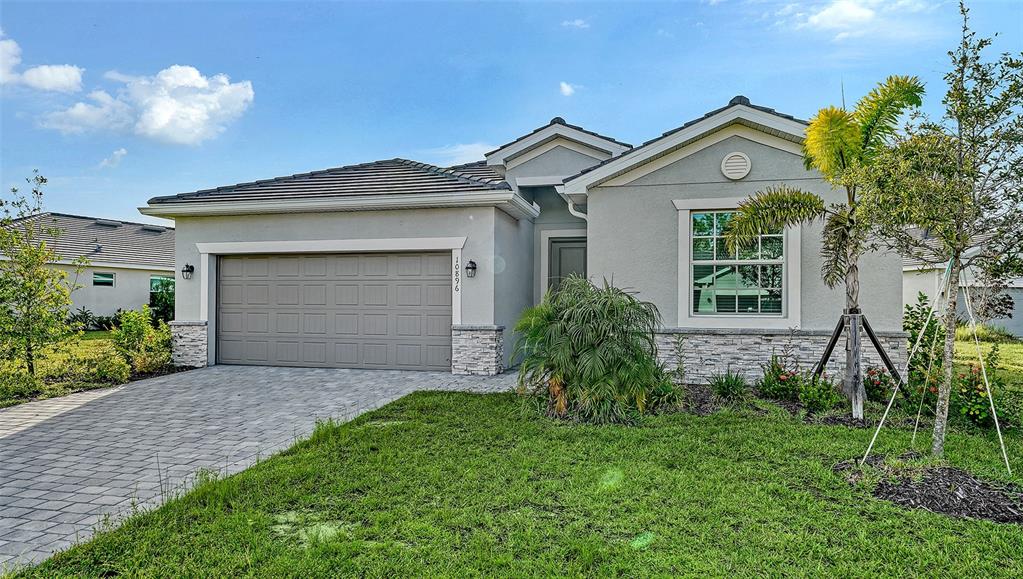10896 Pinot Drive Venice, FL 34293 - Photo 3 of 70 a front view of a house with a garden and plants