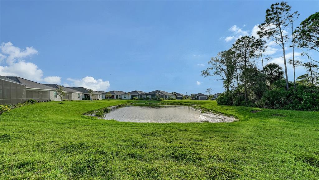 10896 Pinot Drive Venice, FL 34293 - Photo 35 of 70 a view of a lake with houses in the back