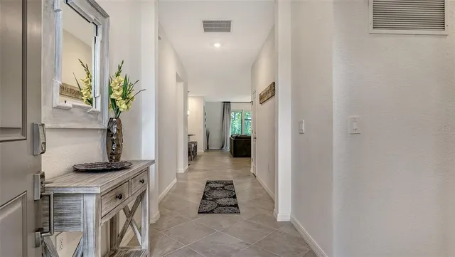 a living room with furniture a chandelier a sink and a flat screen tv