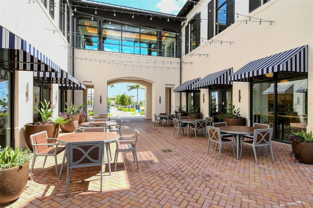 10896 Pinot Drive Venice, FL 34293 - Photo 42 of 70 a building outdoor space with patio furniture and potted plants