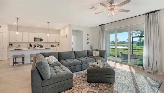 a living room with furniture and a view of kitchen