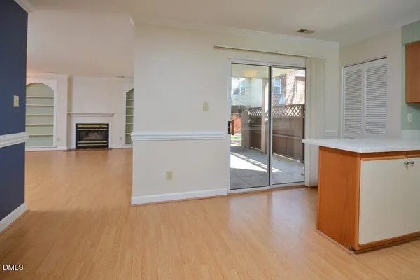a view of a livingroom with wooden floor and a fireplace