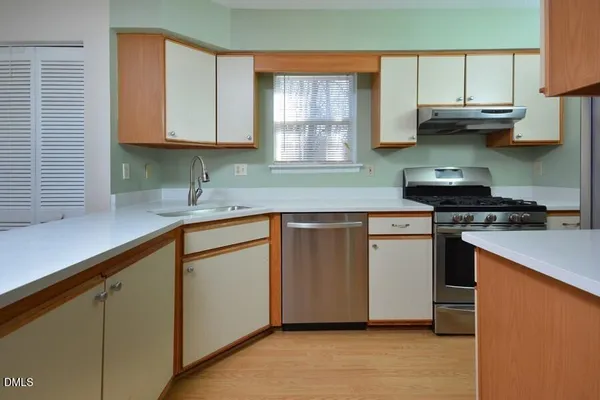 a kitchen with stainless steel appliances granite countertop a sink a stove and a microwave