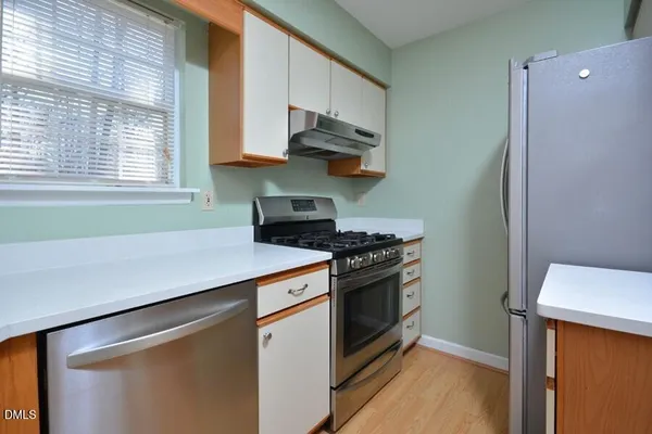 a kitchen with stainless steel appliances a sink stove and cabinets