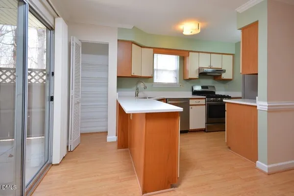 a kitchen with stainless steel appliances granite countertop a stove a sink a refrigerator and a microwave
