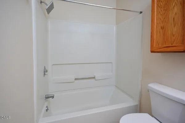 a bathroom with a shower and a toilet