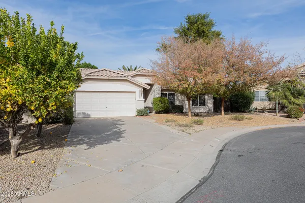 a view of a house with a yard and garage
