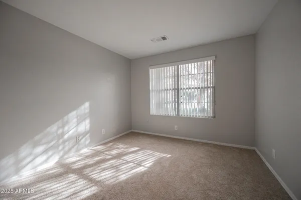 a view of a big room with closet and windows