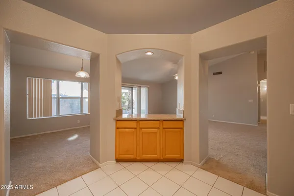 a kitchen with stainless steel appliances granite countertop a refrigerator a sink dishwasher a stove with wooden cabinets and floor