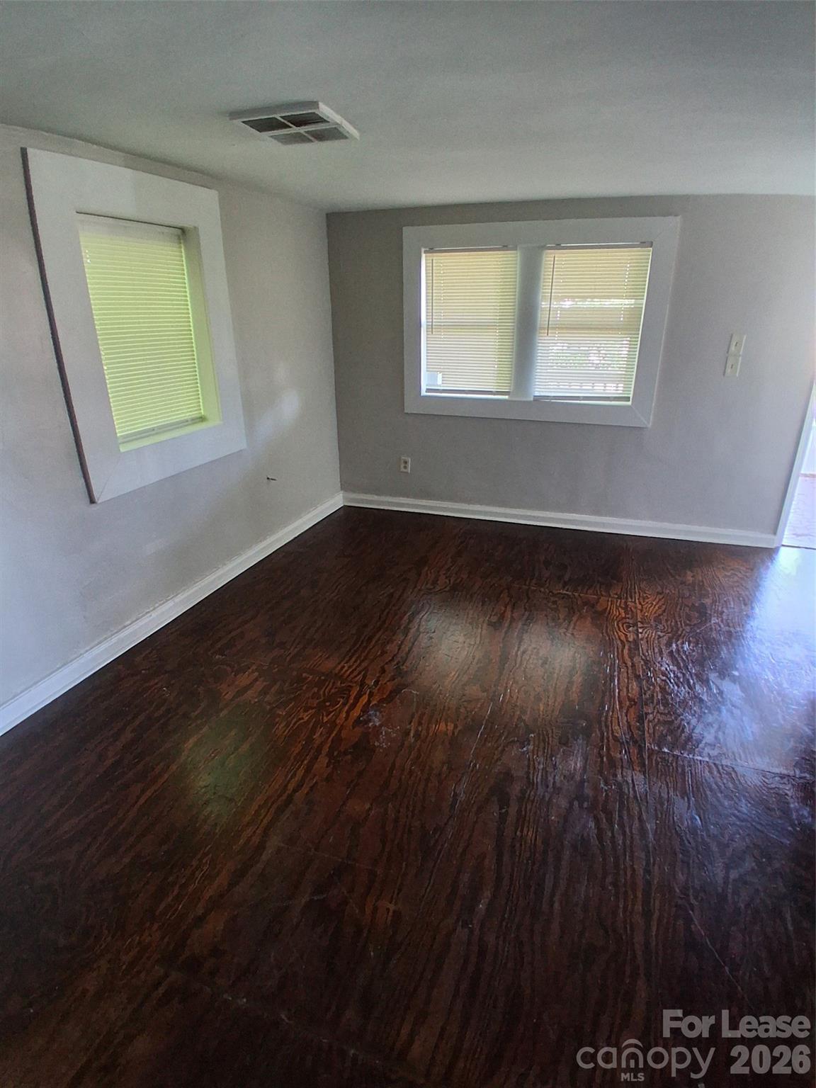 912 Berryhill Road Charlotte, NC 28208 - Photo 10 of 15 a view of an empty room with wooden floor and a window