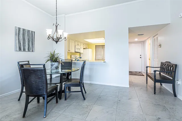 a living room with furniture a window and a flat screen tv