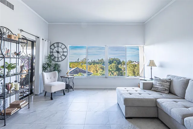 a view of a swimming pool with a balcony furniture and a floor to ceiling window
