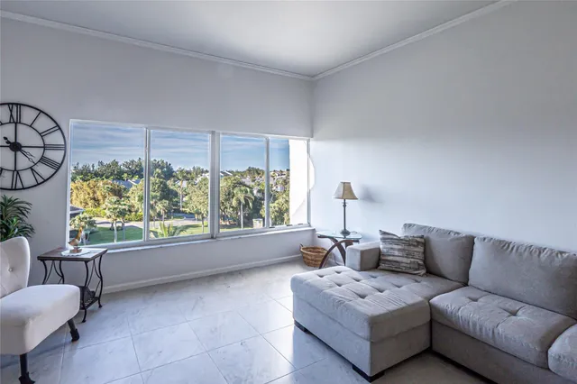 a living room with furniture and a floor to ceiling window