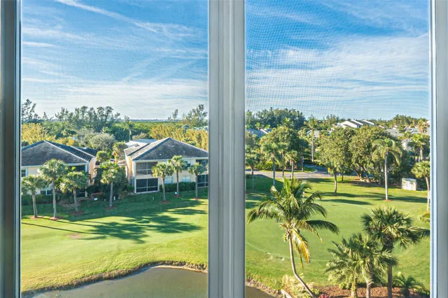 a bathroom with a toilet and a painting on the wall