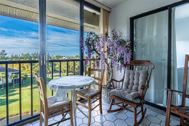 a bedroom with a large bed and a chandelier fan
