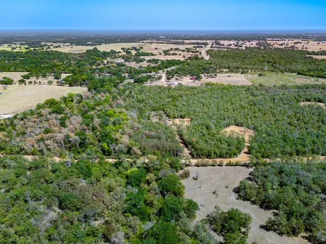an aerial view of residential building and trees around