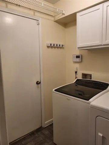 a view of a storage and utility room with washer and dryer