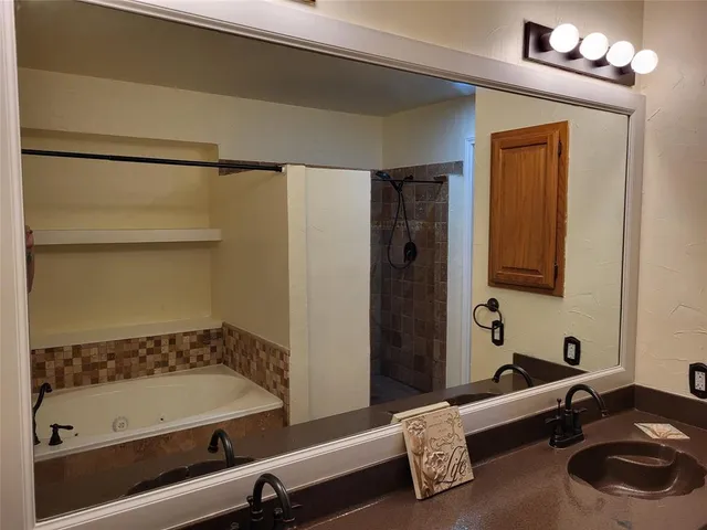 a bathroom with a tub and a sink