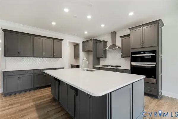 a kitchen with a sink a stove a refrigerator and cabinets