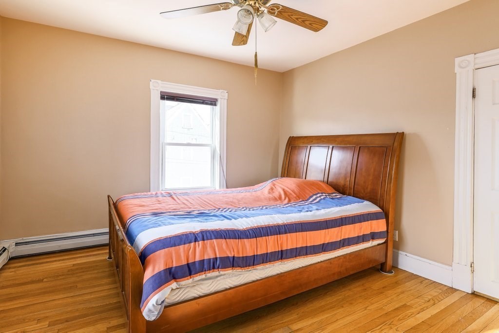 33 Montrose Street Everett, MA 02149 - Photo 21 of 36 a bedroom with a bed and wooden floor