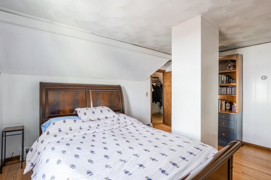 33 Montrose Street Everett, MA 02149 - Photo 25 of 36 a bedroom with a large bed and a wooden floor