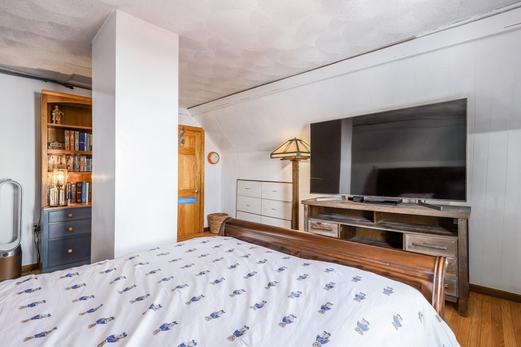 33 Montrose Street Everett, MA 02149 - Photo 26 of 36 a bedroom with a bed and a flat screen tv