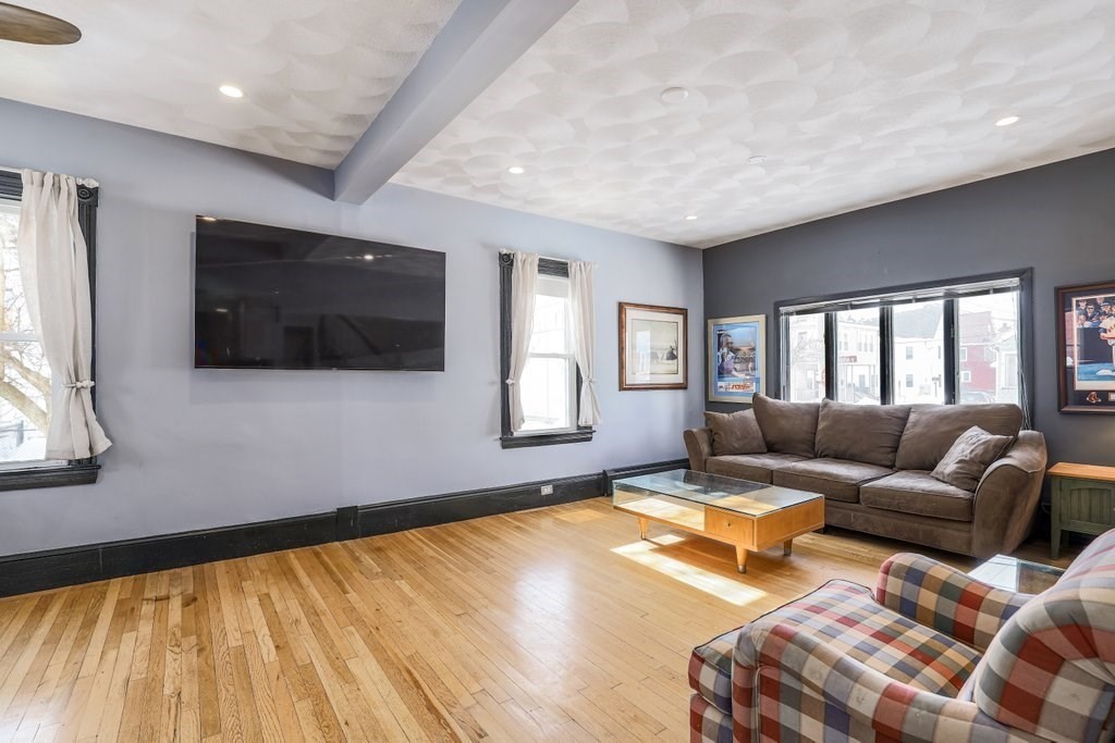 33 Montrose Street Everett, MA 02149 - Photo 3 of 36 a living room with furniture and a flat screen tv