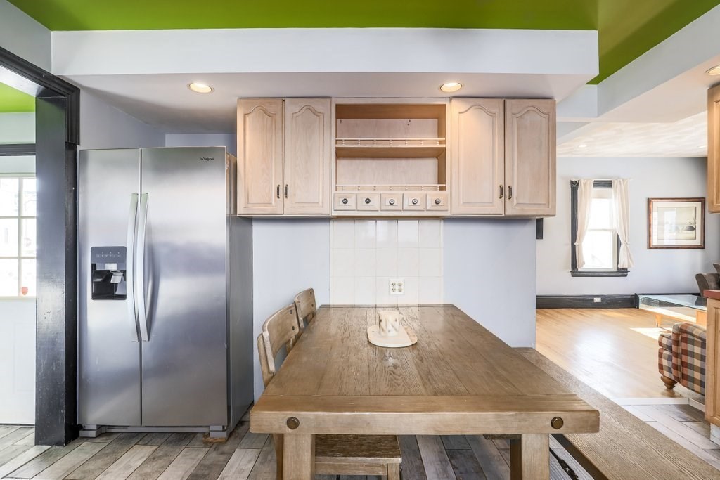 33 Montrose Street Everett, MA 02149 - Photo 9 of 36 a kitchen with kitchen island a counter space and a refrigerator