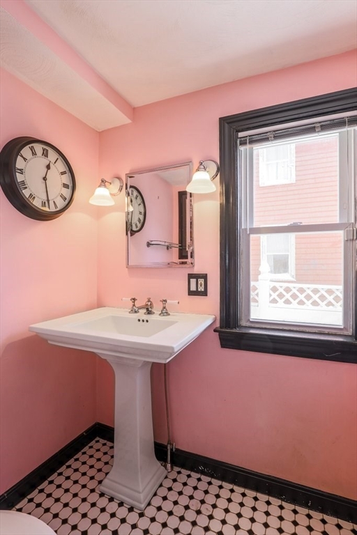 33 Montrose Street Everett, MA 02149 - Photo 10 of 36 a bathroom with a sink a mirror and a window