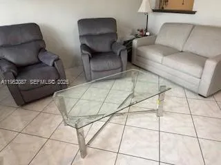 a living room with lots of furniture and a rug