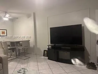 a kitchen with granite countertop a rug a stove and a microwave oven