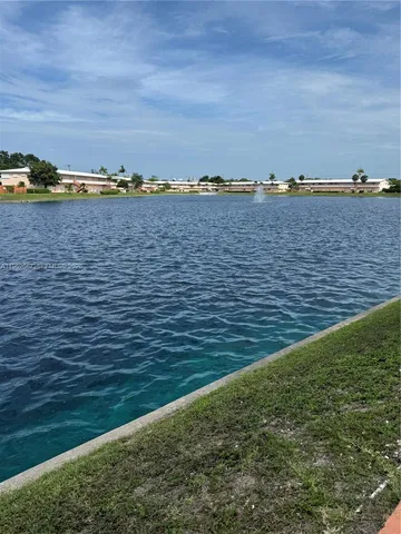a front view of a house with a garden and deck