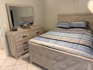 a bedroom with a bed and a mirror
